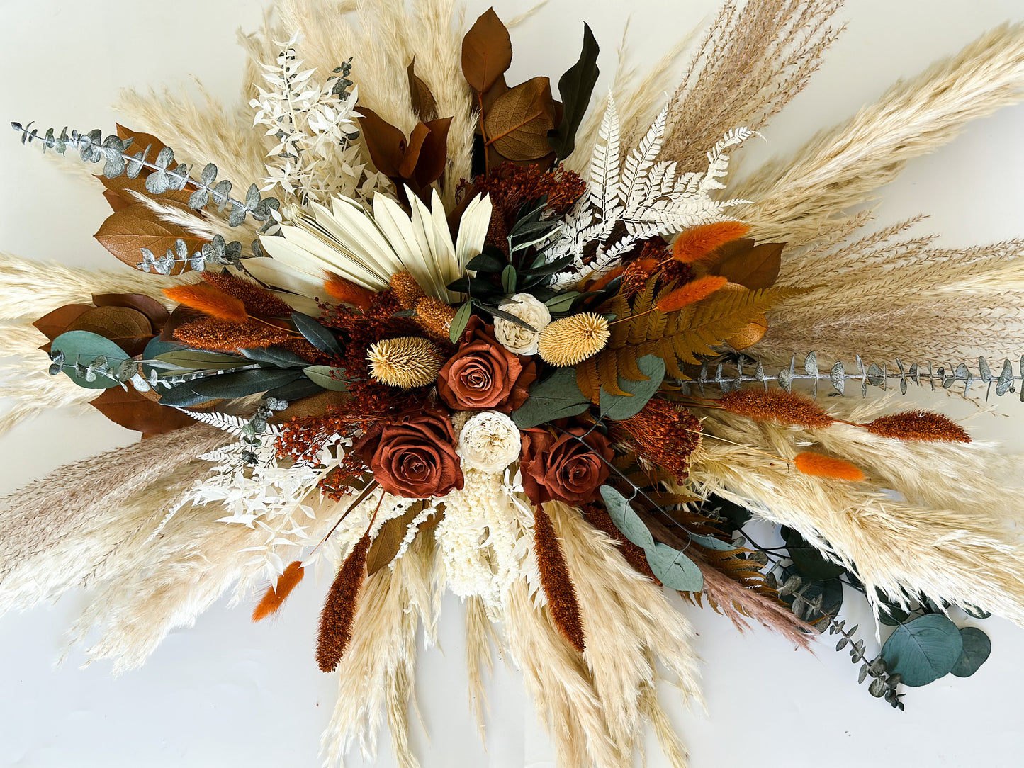 Rust, Terracotta, + Eucalyptus Sweetheart Table Centerpiece
