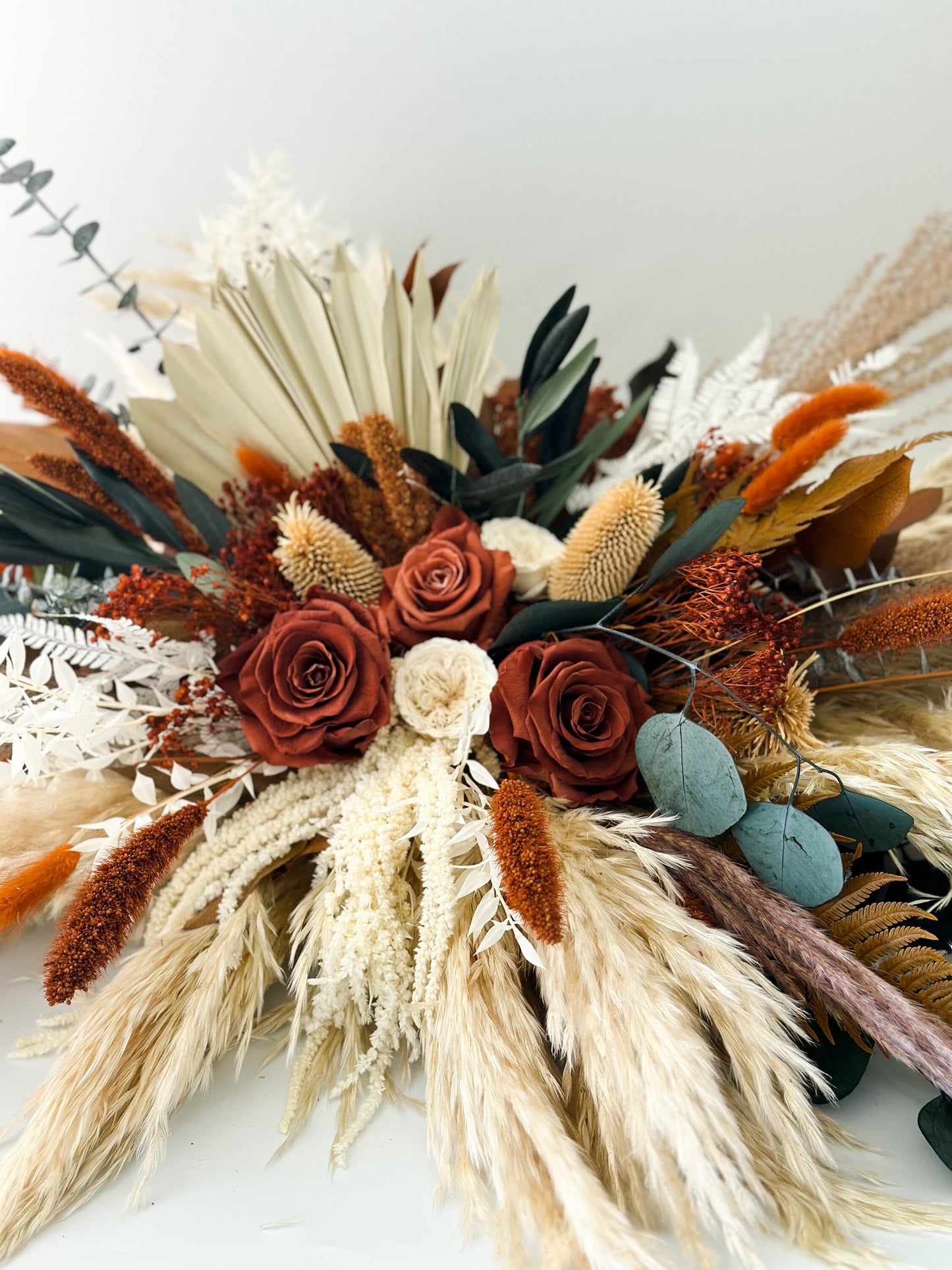 Rust, Terracotta, + Eucalyptus Sweetheart Table Centerpiece